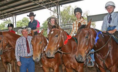 Judge Drew Currie presents under-13 riders with their winning ribbons. Judge Drew Currie presents under-13 riders with their winning ribbons.